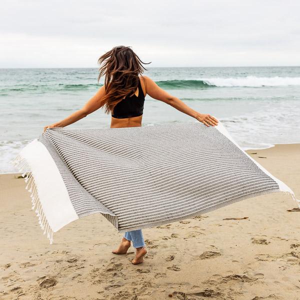 The Stylish Eco Friendly Beach Towel That Doubles As A Throw